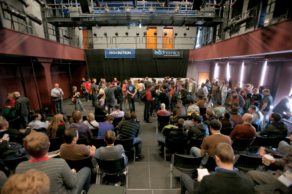 At BarCamp Philly's main hall, 80+ attendees sit as the conference is about to start.